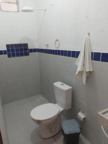 a bathroom with a white toilet and a sink at Pousada Paraíso das Dunas in Barroquinha