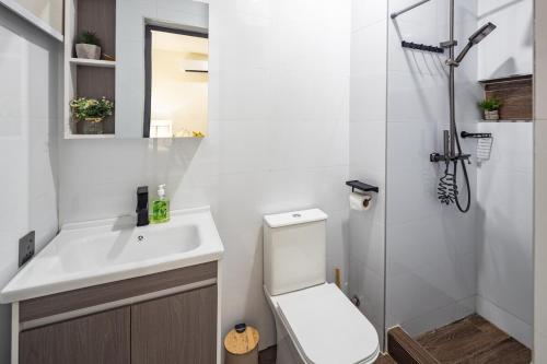 a bathroom with a toilet and a sink and a shower at Grey Assets - Apartment 3 in Spintex