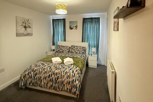 a bedroom with a bed with two pillows on it at 2 Bed - Sleeps 6 - Free Parking in Bracknell
