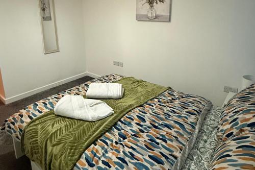 a bed with two pillows on it in a room at 2 Bed - Sleeps 6 - Free Parking in Bracknell