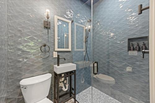 a bathroom with a shower with a toilet and a sink at SM08: 8 Silver Moss in Kiawah Island
