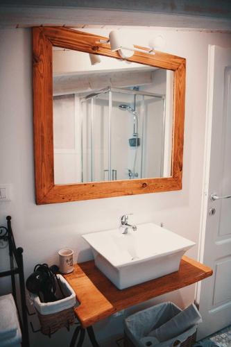 a bathroom with a sink and a mirror at Lavandula House in Štanjel