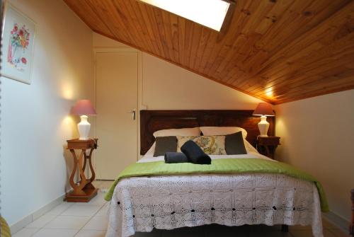 a bedroom with a large bed with two lamps at la belle étape in Osséja