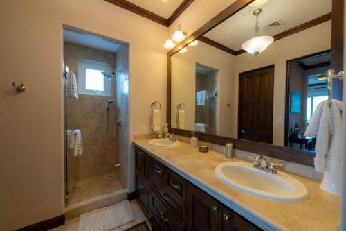 a bathroom with two sinks and a shower at AltaVista 4C 3 bdr Ocean View in Los Suenos in Herradura