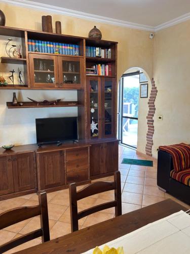 a living room with a large entertainment center with a television at Casa Vacanze Vanessa House in Ladispoli