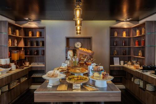 a bakery with several plates of food on a table at Sofitel Strasbourg Grande Ile in Strasbourg
