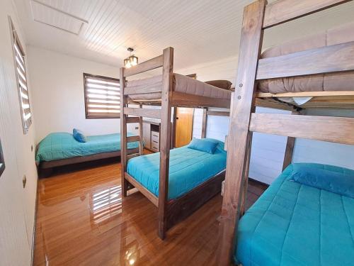 a room with two bunk beds in a house at Quillon Cabaña Privada Vista al Valle in Quillón