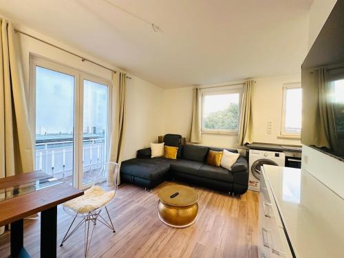 a living room with a couch and a table at YAYstay - Forest I 65m2 I Balcony I TV I Bahnhof in Mühldorf