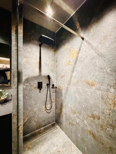 a shower with a shower head in a bathroom at New Premium LOFT studio in Zhytomyr