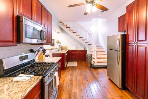 a kitchen with a stove and a refrigerator at St. Ann Historic Creole Cottage 5 bed-4ba in New Orleans