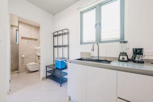 a white kitchen with a sink and a bathroom at Private Suite HotTub in Santa Cruz