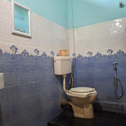 a bathroom with a toilet and a shower at Atithi Homestay in Sivasagar