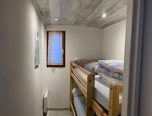 a bedroom with two bunk beds and a window at Gite Clarabide in Loudenvielle