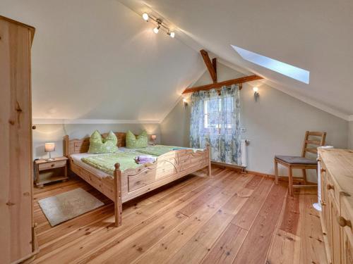 a bedroom with a large wooden bed and a window at Kegel in Lohsdorf