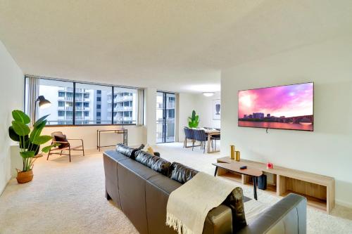 a living room with a couch and a table at Well-Equipped Apartment Close to Metro Station in Addison Heights