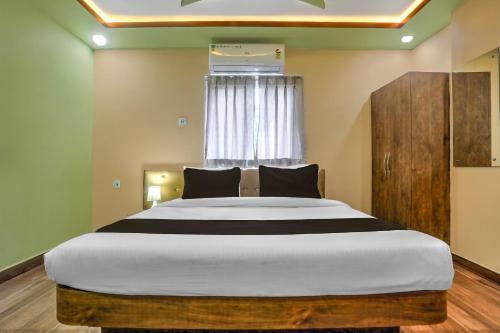 a bedroom with a large bed in front of a window at SPOT ON Hotel Blue Diamond Inn in Bihta