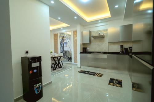 a living room with a kitchen with a counter at Bubbles Cozy Homes Two bedroom apartment in Mombasa