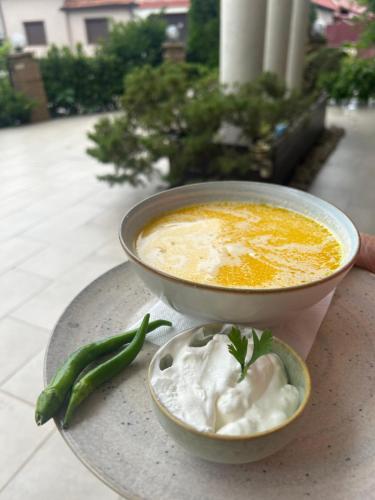 a bowl of soup and a bowl of dumpling at Pensiunea Boema in Lancrăm
