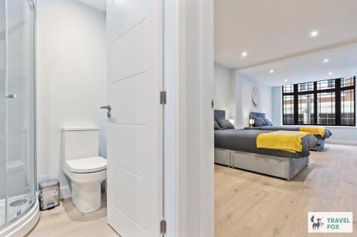 a bedroom with two beds and a toilet at Blair's Central Stay in Nottingham
