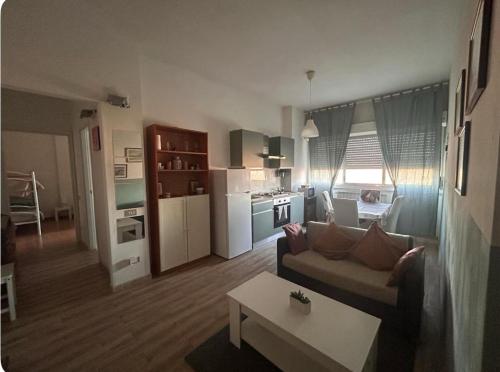 a living room and kitchen with a couch and a table at B&B MaKri in Boltiere