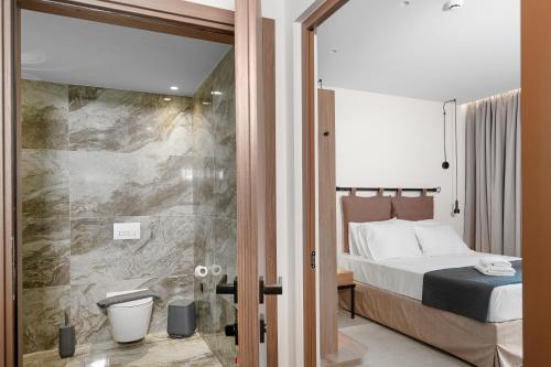 a bedroom with a bed and a glass door at Luxury Suites with private pool and BBQ by Kalles Homes & Suites in Áno Kalésia