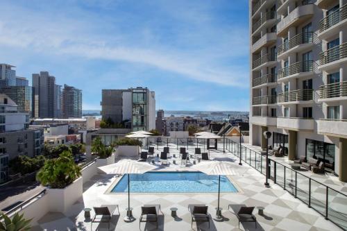 an apartment patio with a swimming pool on a building at Courtyard by Marriott San Diego Downtown Little Italy in San Diego