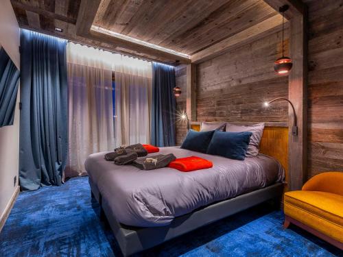 a bedroom with a large bed in a room with wooden walls at Superbe appartement 6 pièces, luxe et confort, piscine et SPA, 10 pers., Morzine - FR-1-314-99 in Avoriaz