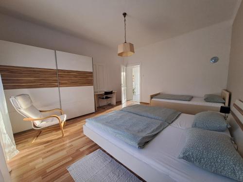 a bedroom with a bed and a chair in it at Apartman Soda in Ogulin