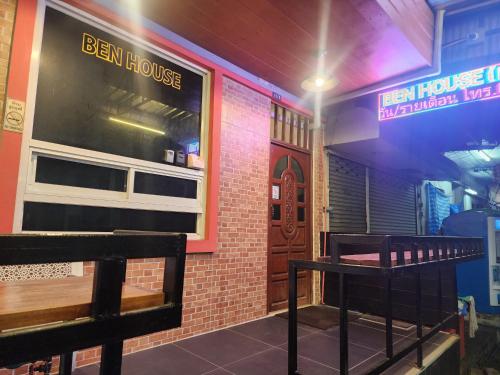 a restaurant with a bench in front of a building at BEN HOUSE in Bangkok