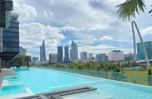 a swimming pool with a city skyline in the background at The Metropole Deluxe Apartment View City in Ho Chi Minh City