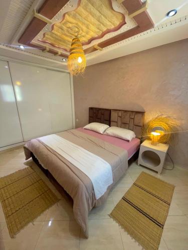 a bedroom with a bed with a painting on the ceiling at Papaya Hostel in Agadir
