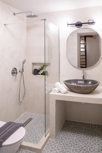 a bathroom with a sink and a glass shower at Milies Memories Pelion in Mileai