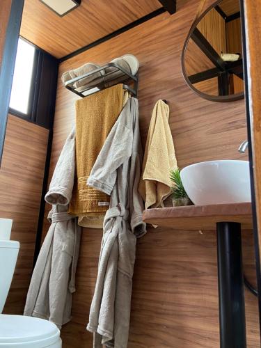 a bathroom with towels hanging on a wall at Mini Cabana Makar in Serra do Cipo