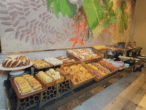 a buffet with many different types of pastries on display at Palladio Hotel Buenos Aires - MGallery Collection in Buenos Aires