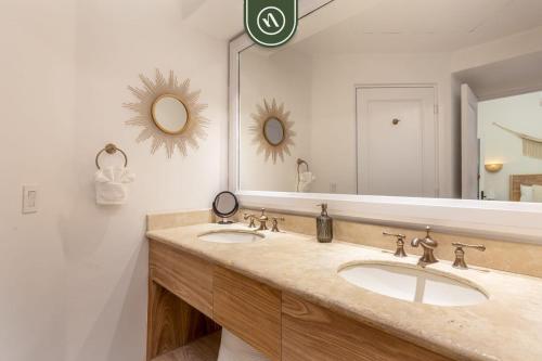 a bathroom with two sinks and a large mirror at Oceanview Condo in Cabo with Beach - Pool in El Tule