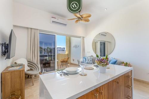 a kitchen and living room with a table and a mirror at Oceanview Condo in Cabo with Beach - Pool in El Tule