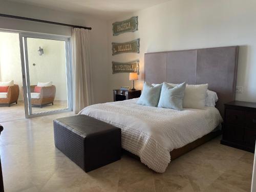 a bedroom with a large bed and a chair at Tortuga Bay TBB 2502 in San José del Cabo