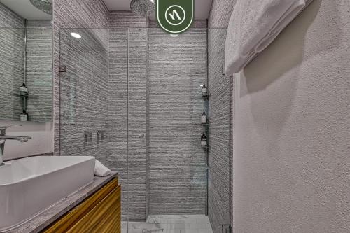 a bathroom with a shower and a white sink at 2BR Condo with Private Balcony - Padel Court in Nuevo Nayarit