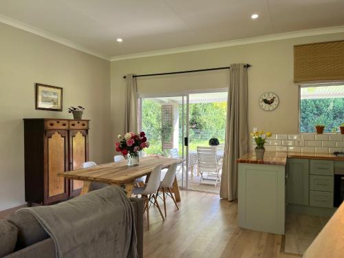 a kitchen and dining room with a table and chairs at Autumn Way in Clarens