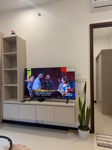 a large flat screen tv in a living room at Trizen Colombo stylish high rise condo -Vistablu 32 in Colombo