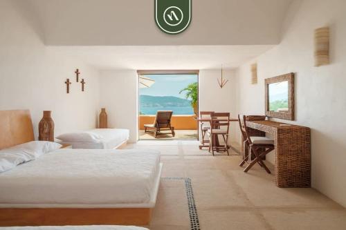 a living room with a bed and a table and chairs at 4 BR Penthouse - Breathtaking Views - Private Pool in Ixtapa