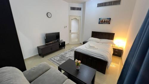 a living room with a bed and a couch at XD Cozy Apartments in Abu Dhabi