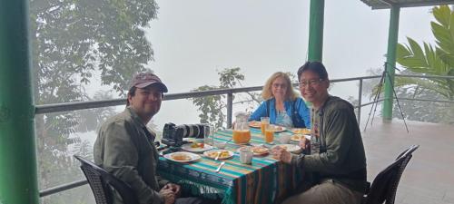 a group of three people sitting at a table with food at Mashpi Amagusa Lodge in Mashpi