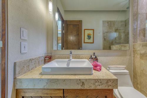 a bathroom with a sink and a toilet at Chic Studio -Rooftop Pool - Ocean View - King Bed in Puerto Vallarta