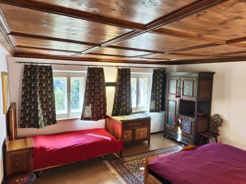 a bedroom with two beds and a window at Alma Hunting Lodge in Borca di Cadore