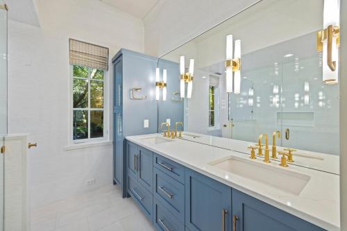 a blue bathroom with a sink and a mirror at 5556 Cypress Point in Kiawah Island