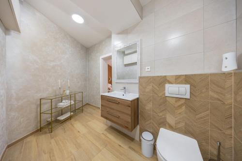 a bathroom with a sink and a toilet at Luxury 2BR Apartment - Old Town Bratislava Center in Bratislava