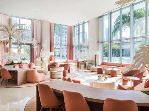 a lobby with a lot of furniture and windows at Novotel Miami Brickell in Miami
