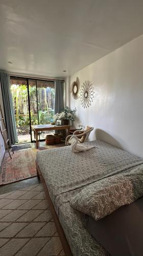 a bedroom with a bed and a large window at Paradiso Hostel Siargao in General Luna
