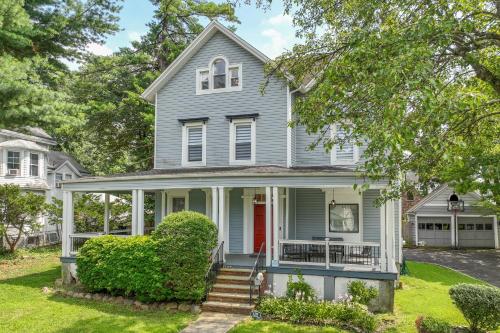 a gray house with a red door at Casa Francesca 6BR Villa & Heated Pool in Roselle